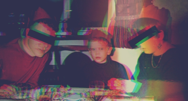 My Parents and I in the 90s at a table